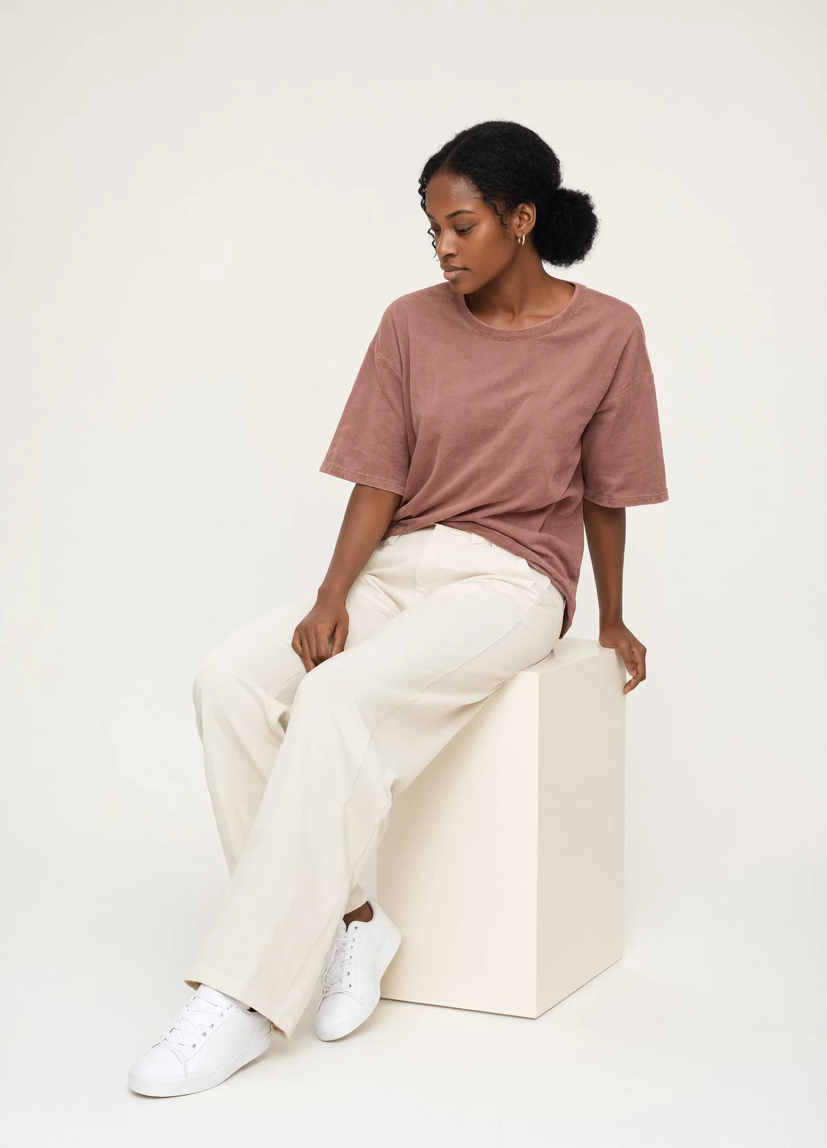 nabi Heavyweight Faded Tee in Ember Rose (dusty rose), seated, three-quarter view