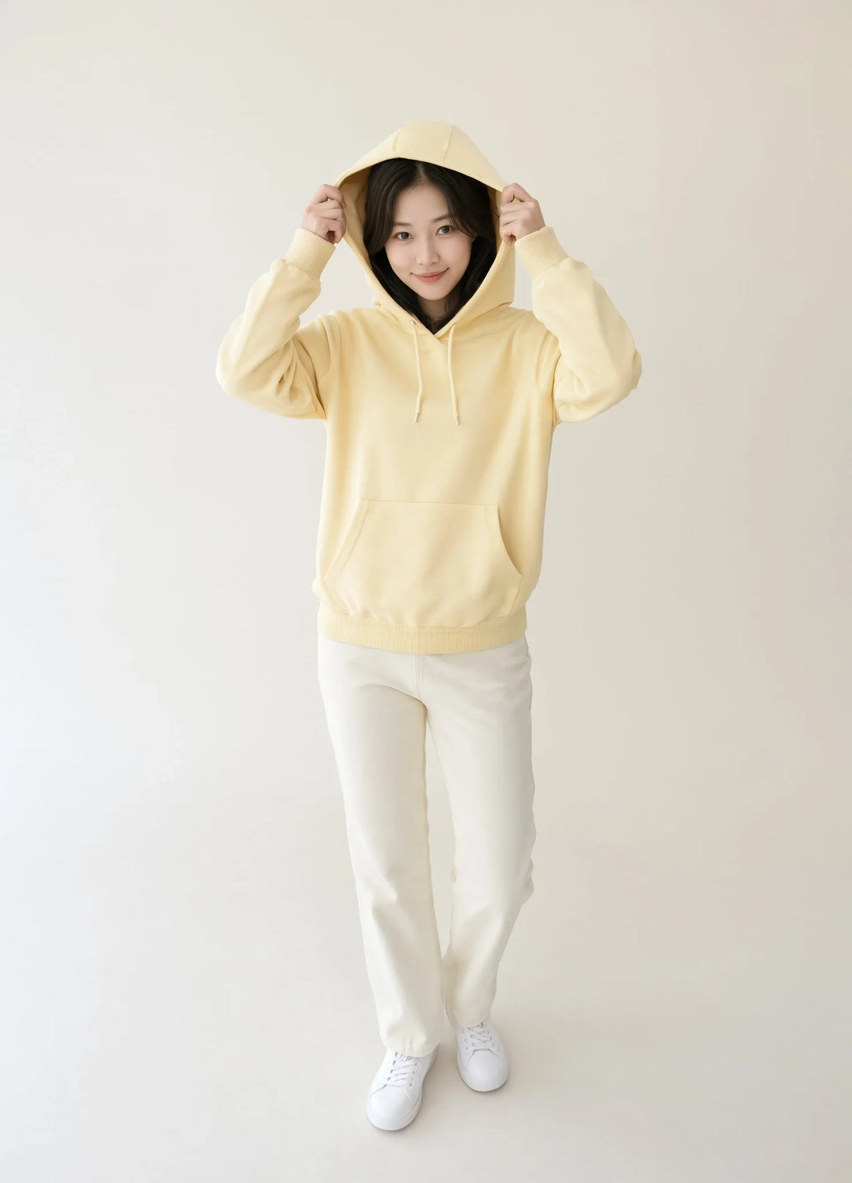 nabi Pullover Hoodie in Sunday Butter (soft butter yellow), hood up, front view