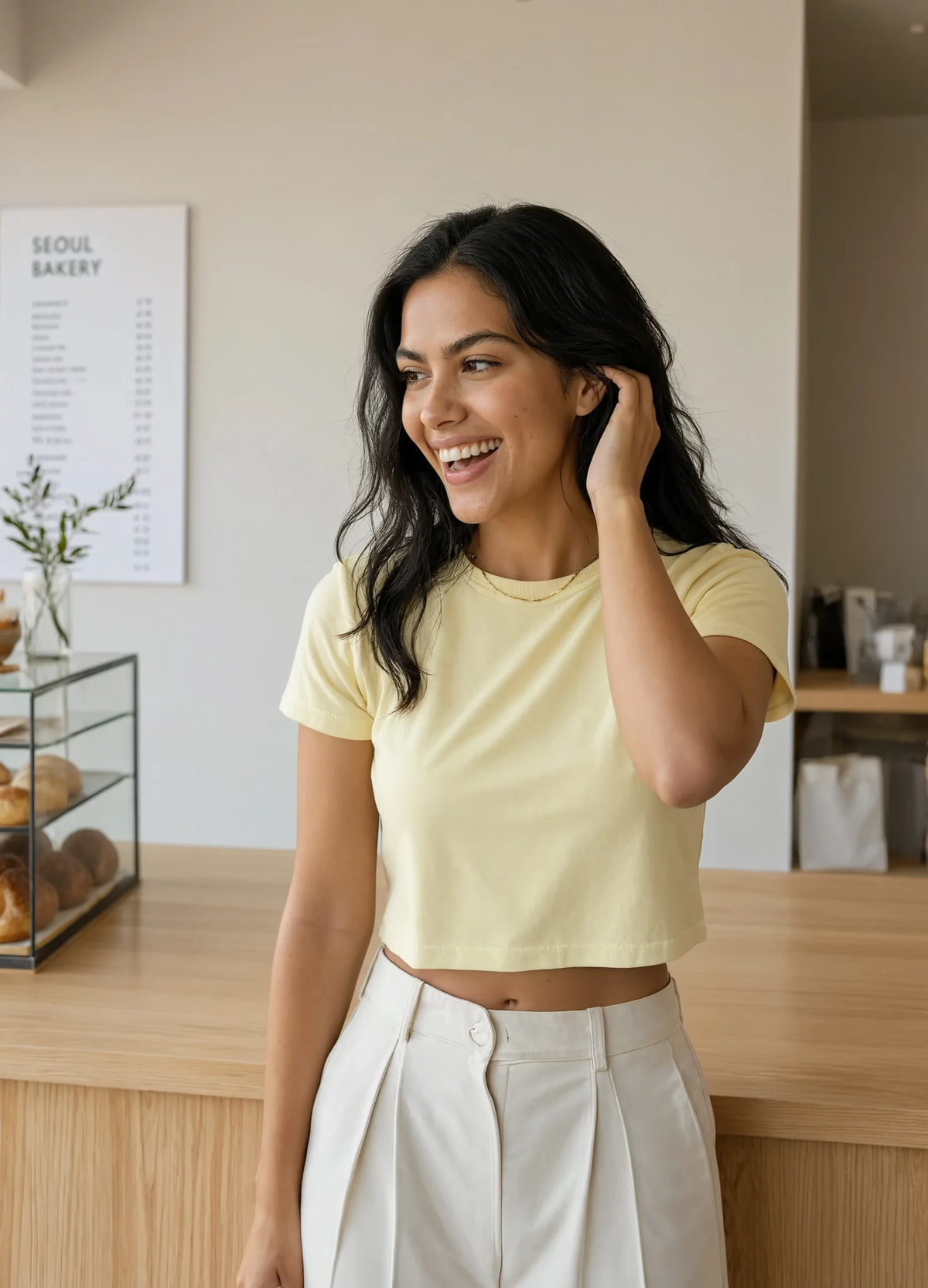 nabi Relaxed Crop Tee in Sunday Butter (soft butter yellow), waist up, cafe