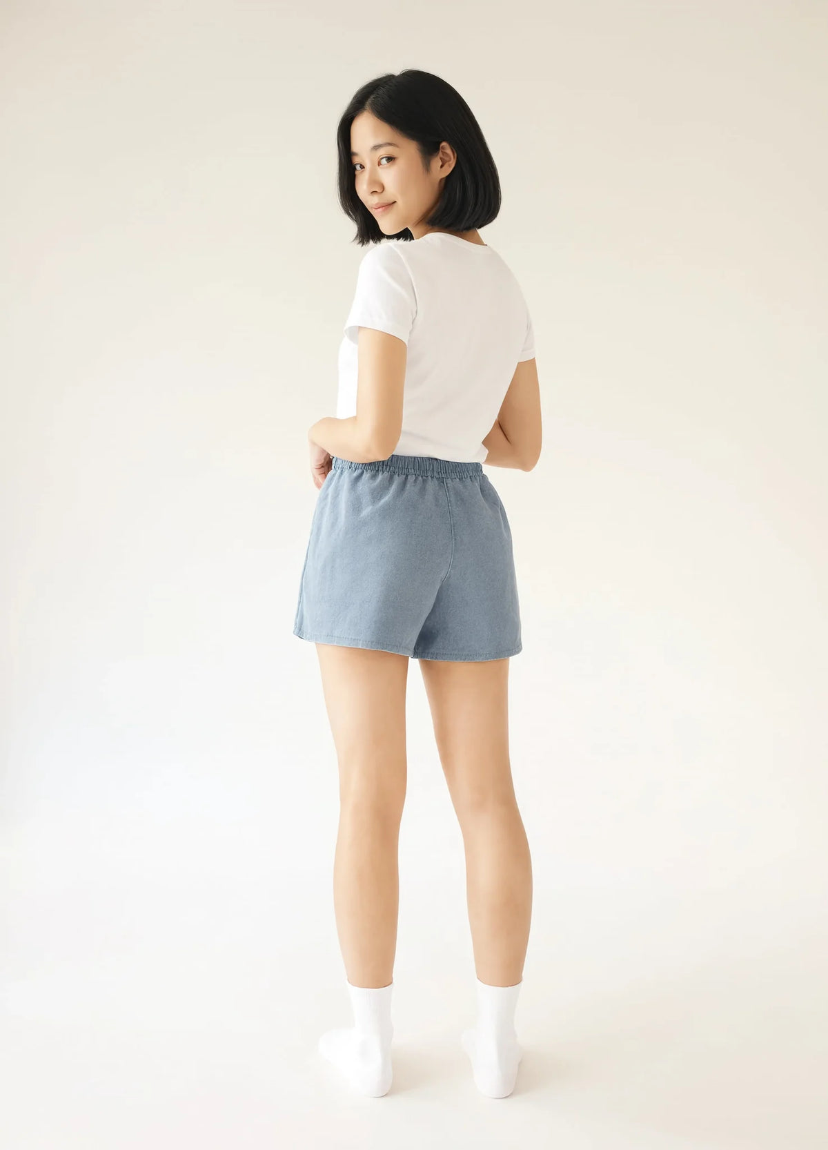 nabi Sweat Shorts in Washed Chambray (washed blue), back view on model