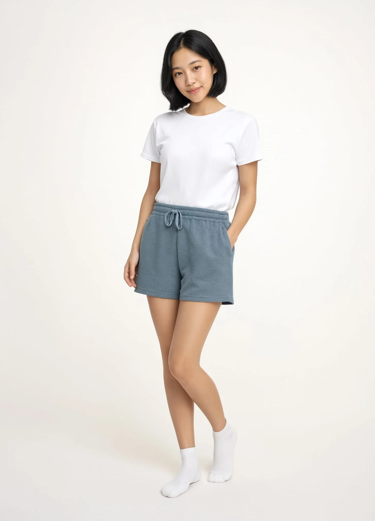 nabi Sweat Shorts in Washed Chambray (washed blue), leaning, three-quarter view
