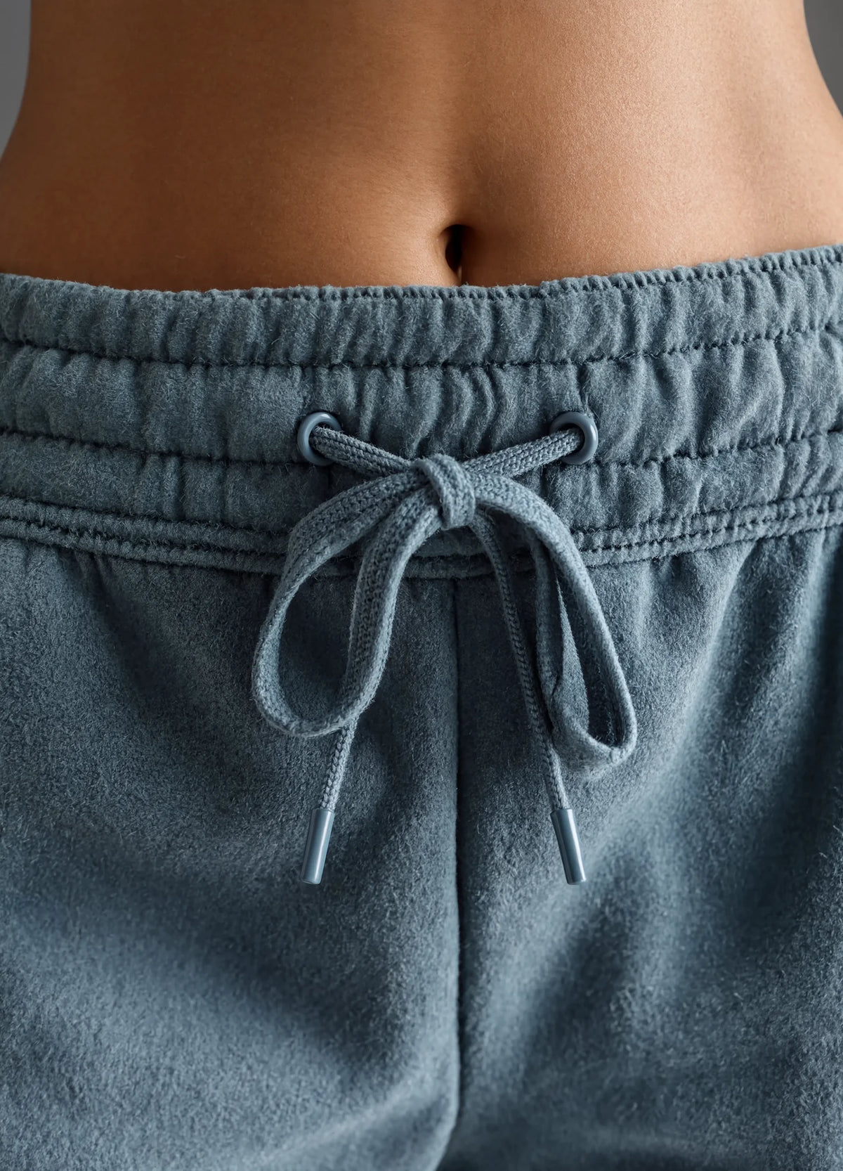 nabi Sweat Shorts in Washed Chambray (washed blue), drawcord bow and eyelets close-up