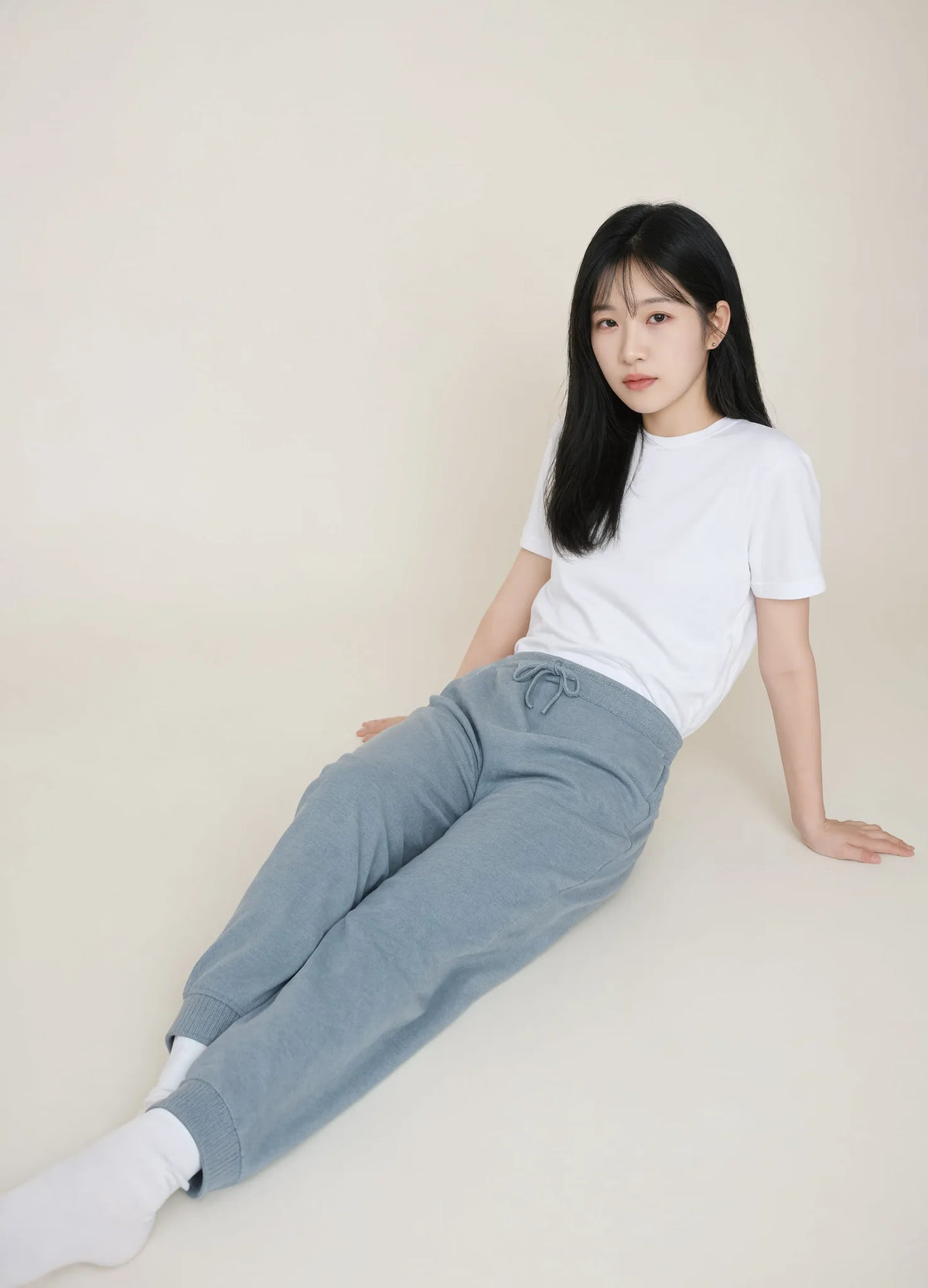nabi Wash Sweatpants in Washed Chambray (washed blue), seated on the floor