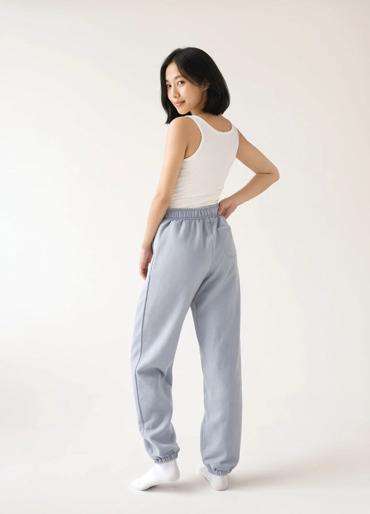 nabi Track Pants in Washed Chambray (washed blue), back view on model
