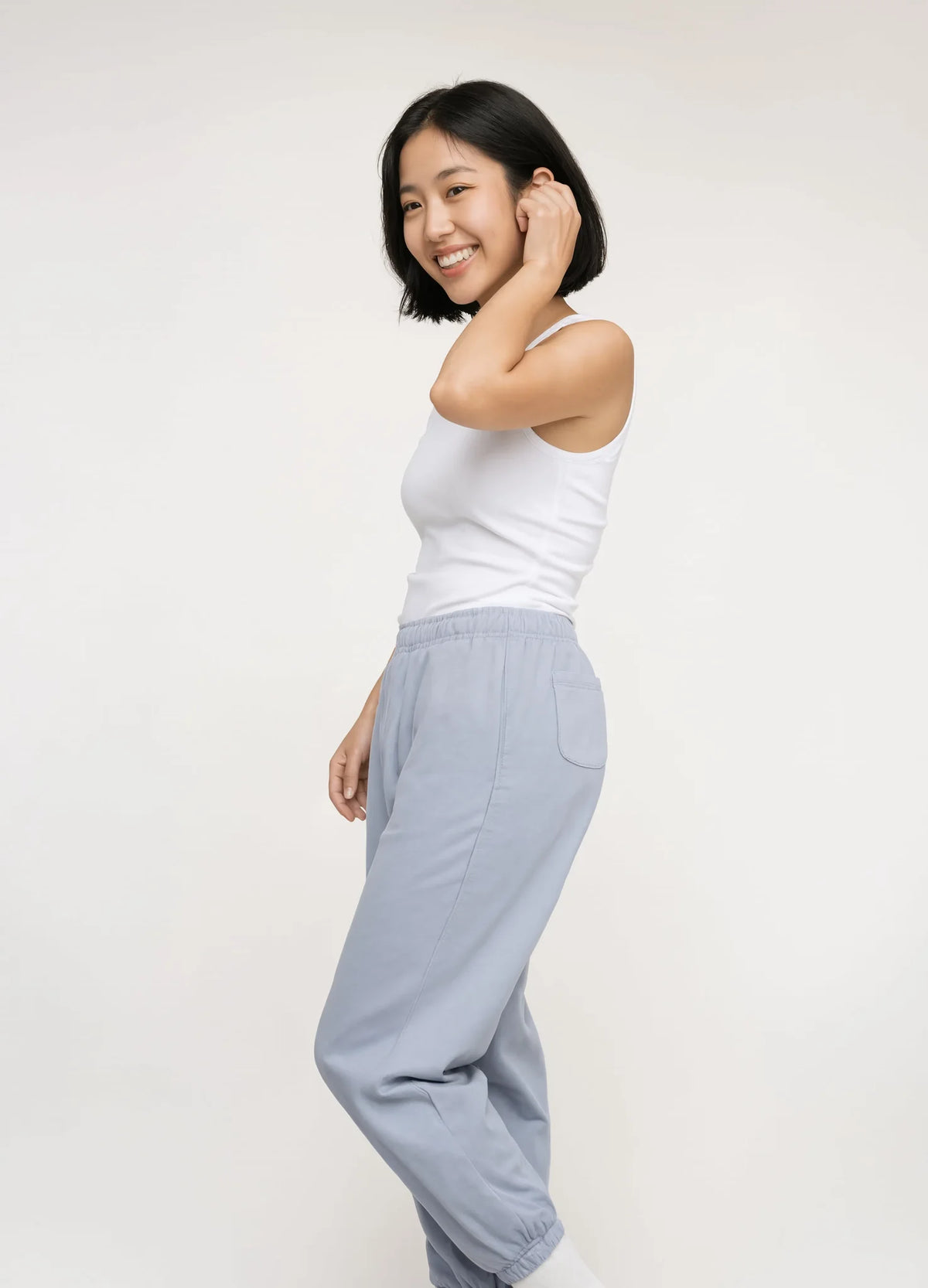 nabi Track Pants in Washed Chambray (washed blue), side view on model