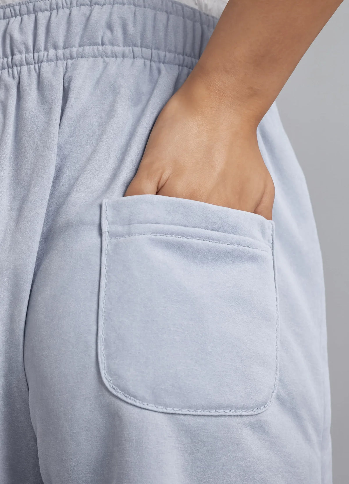 nabi Track Pants in Washed Chambray (washed blue), back patch pocket close-up