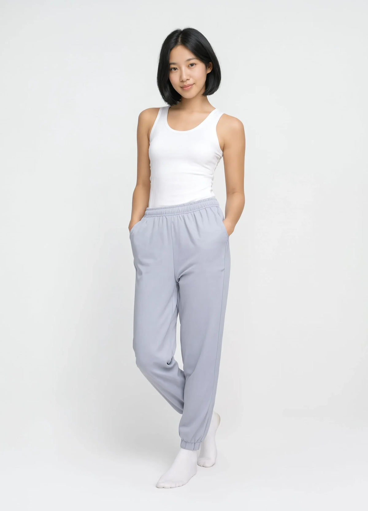 nabi Track Pants in Washed Chambray (washed blue), front view on model