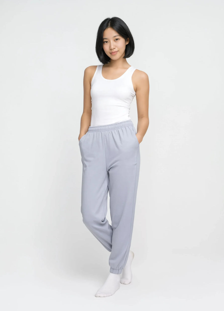 nabi Track Pants in Washed Chambray (washed blue), front view on model